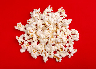 Popcorn in red and white cardboard box. Popcorn border isolated on white. Film. Fast food. Corn