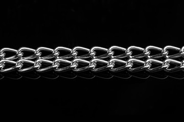 Chain heap - abstract metal background. Collection silver jewelry chains on an isolated black...
