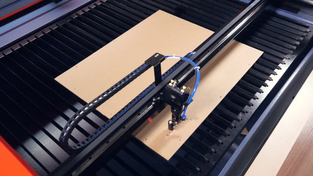 Industrial laser system engraving on wood.