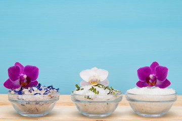 set of white salt with additives for spa treatments, and orchids