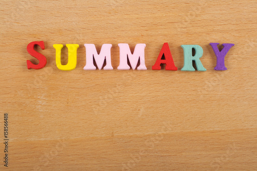 "SUMMARY word on wooden background composed from colorful abc alphabet