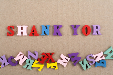 SHANK YOR word on wooden background composed from colorful abc alphabet block wooden letters, copy space for ad text. Learning english concept.