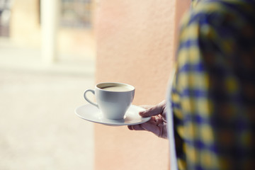 Low angle view of bartender carrying coffee