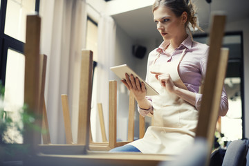 Confident waitress doing checklist in restaurant