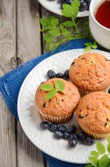 Homemade  blueberry muffins on rustic wooden background, selective focus