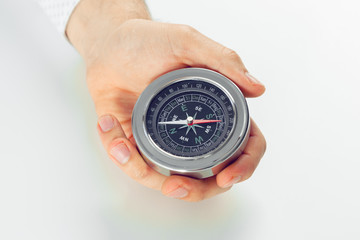 Businessman with a compass holding in hand