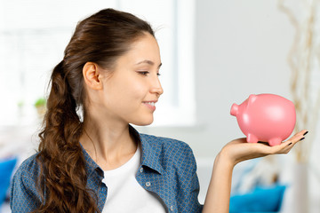 Young woman with piggy bank