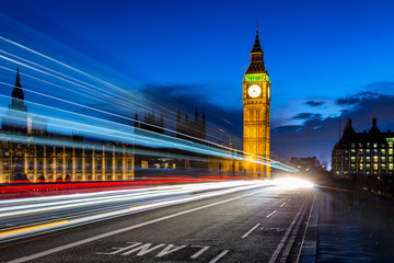 Big Ben and London at night with the lights of the cars passing by, the most prominent symbols of...