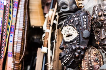 Fototapeten traditional african wooden carevd tribal masks at market © Ievgen Skrypko