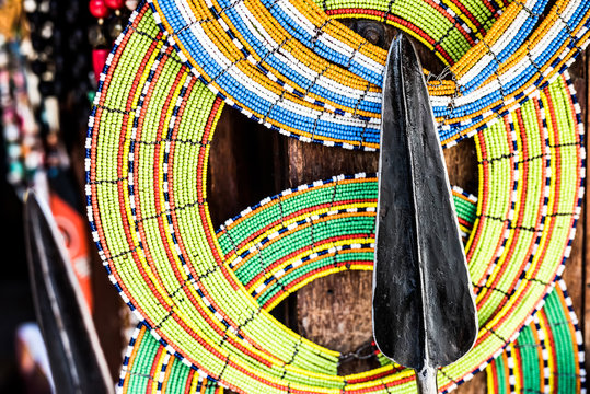 tnational african handmade colorful decorations and tribal spear on Zanzibar market
