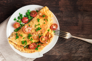Omelette with parsley, cherry tomatoes, and copyspace