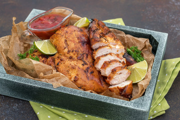 Grilled chicken breast served with herbs and lime