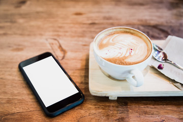 cup of coffee and mobile phone on  table