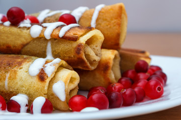 Traditional sweet rolled pancakes with poppy seeds on the plate