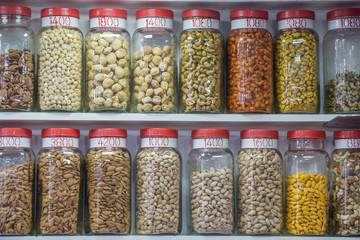 Different kinds of nuts for sale in plastic jars