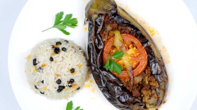 Turkish cuisine. Karniyarik and rice pilaf with black corinth raisin. Eggplant stuffed ground meat. 1920x1080p HD Video