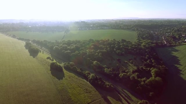 Panning sunrise aerial shot over the Epsom Downs.