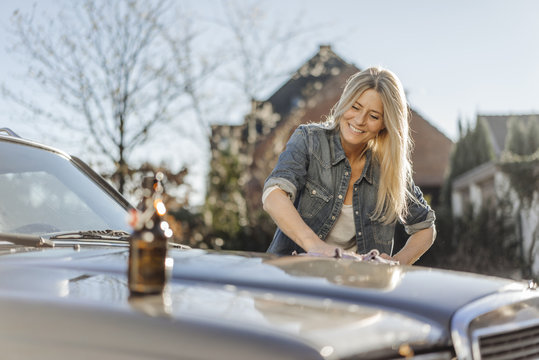 Woman cleaning her car