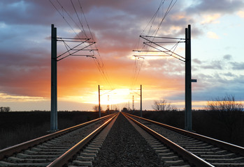 Obraz na płótnie Canvas Dramatic sunset over railroad