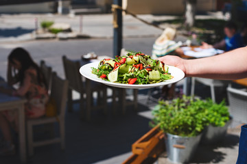 Concept: vegetarian food, nutrition, diet. Salad with arugula, strawberries and cucumber.