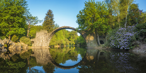 Devil's bridge in the park Kromlau, Germany,Flowering rhododendrons