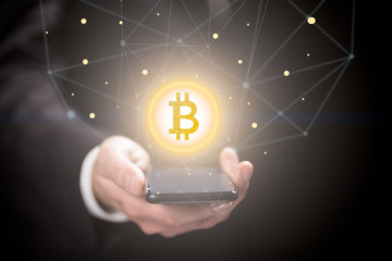 Businessman with bitcoin sign , smartphone