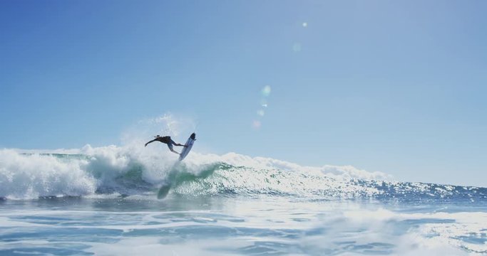 Young Man Surfing Ocean Wave in Slow Motion
