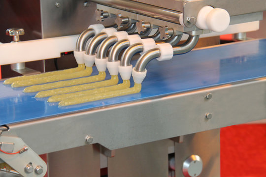 A Food Processing Machine Extruding Strips of Food.