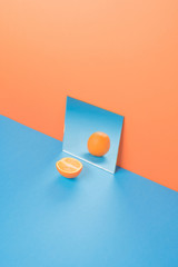 Orange on blue table isolated over orange background