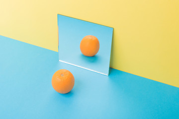 Grapefruit on blue table isolated over yellow background