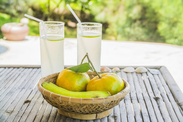 the cocktail in the glasses near the tropical fruits