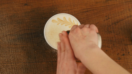 Barista preparing cappuccinno latte art coffee in to white cup
