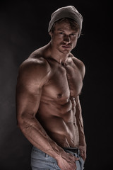 Fototapeta na wymiar Strong Athletic Man Fitness Model on black background