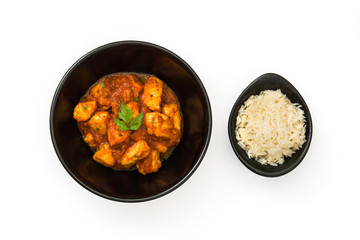 Chicken tikka masala in bowl with basmati rice isolated on white background
