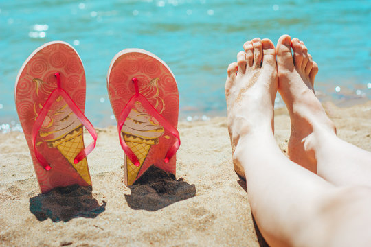 feet and flip-flops on beach