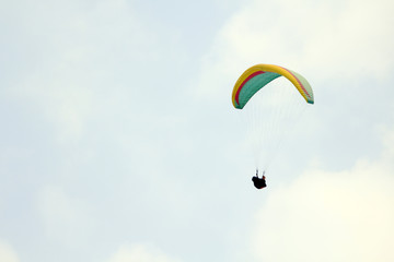 Paragliding over the mountains against clear blue sky