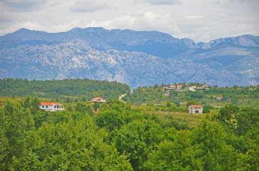 Fototapeta premium The cozy villages of Croatia mountains in the background