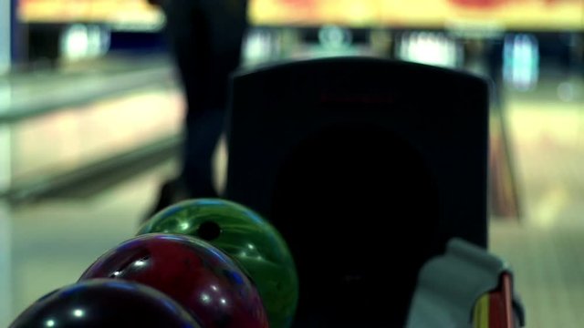 Bowling game. Bowling balls lie on stand