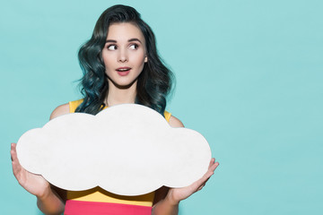 Beautiful woman holding empty blank form in the form of clouds.