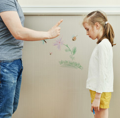 Little girl spoiled the wallpaper and her dad is angry.