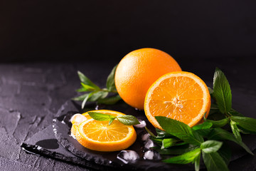 Green fresh mint and juicy orange background. Selective focus.
