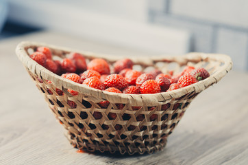 the child in the kitchen eating strawberries