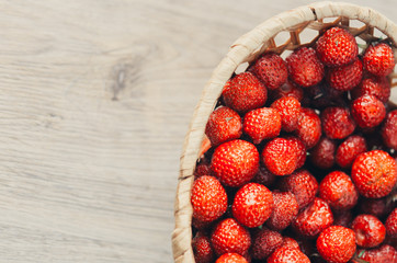 the child in the kitchen eating strawberries