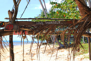 Travel to island Koh Lanta, Thailand. Inscriptions “Love yourself”, “Love peace harmony” on...