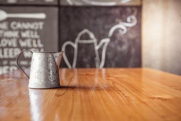 A vase placed on the table. Wooden table.