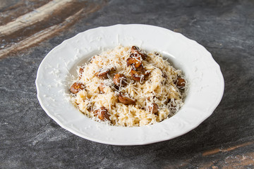 Mushroom risotto with parmesan cheese. Italian food. Simple background.