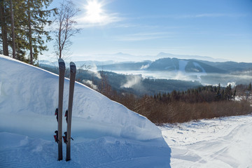 skis stand near a large snowdrift