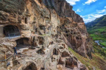 Tourists visiting Vardzia ancient cave city on a spring day in May. Vardzia is one of the main attraction in Georgia