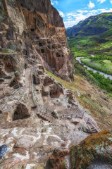 Tourists visiting Vardzia ancient cave city on a spring day in May. Vardzia is one of the main attraction in Georgia