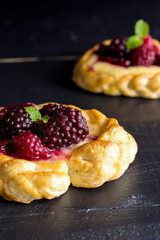 Vanilla Cream and Fruit Berry Puff Pastry Dessert on Dark Background